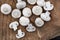 Raw White button mushrooms on rustic styled table surface