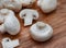 Raw White button mushrooms on rustic styled table surface