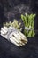 Raw white and green Asparagus with flower on an old rustic metal sheet