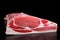 Raw whole back bacon loin on black board background