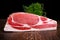 Raw whole back bacon loin with herb