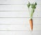 Raw whole carrot on wooden surface table