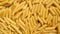 Raw whole dried Penne rigate pasta