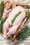 Raw whole farm goose on butcher cutting board. White wooden background. Top view