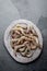 Raw whole fresh uncooked prawns shrimps on stone gray plate, stone background. Top view with copy space