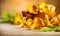 Raw wild chanterelle mushrooms on old rustic table background. Organic fresh chanterelles background