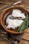 Raw wolffish or wolf fish fillet in a wooden plate. wooden background. Top view