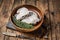 Raw wolffish or wolf fish fillet in a wooden plate. wooden background. Top view