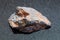 raw Wolframite stone (tungsten ore) on dark