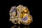 Raw wulfenite mineral stone on mother rock in front of black background