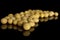 Raw yellow soya bean isolated on black glass