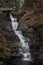 Raymondskill Falls in Autumn surrounded with brilliant fall foliage