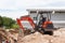 Rayong Thailand - Sep 9 2014: Worker driving excavator to placing sand for construction and several workers were digging sand.