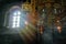 Rays of light in an ancient stone church. Sun's rays in dark stone temple. Lighting effects on the chandelier. Selective