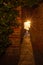 The rays of the setting sun shine through the narrow long arch of the building of the monastery on Mount Athos