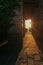 The rays of the setting sun shine through the narrow long arch of the building of the monastery on Mount Athos