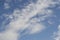 rays of the sun through the cirrus clouds against the blue sky, white rainy clouds blue sky illuminated by the rays of the sun