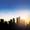 Rays of sunlight shine through the buildings of the Manhattan skyline at sunset in New York City