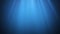 Rays of sunlight shining from above penetrate deep clear blue water. Sun light beams underwater. Small bubbles move up