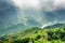 Rays of sunlight through storm clouds in mountains of Vietnam