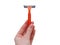 Razor in a female hand on a white background. Removal of unwanted hair. top view. Concept of using razor. Orange men`s razors