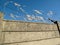 Razor wire security protection on concrete wall