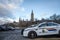 RCMP GRC Police car standing in front of the Canadian Parliament Building.