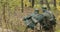 Re-enactors Dressed As German Wehrmacht Infantry Soldiers In World War II Soldier Sitting In Ambush In Autumn Forest And