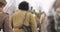 Re-enactors Dressed As Russian Soviet Soldiers Of World War II Marching Along Forest Road At Winter Season