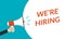 We`re hiring announcement with hand is holding a megaphone or loud speaker. Recruitment, HR design concept. Hire for the Job