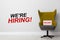 We`re hiring! Comfortable office chair with sign VACANT near light wall indoors