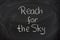 Reach for the sky phrase on blackboard