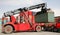 Reach stacker vehicle moving a container into a container terminal area