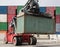Reach stacker vehicle moving a container into a container terminal area