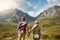 Reaching new heights as a couple. Rearview shot of a young couple admiring a mountainous view in nature.