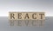 REACT concept, wooden word block on the grey background