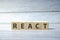 react word on the wooden blocks and wooden table