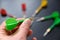 Read in the hands of a man taking aim with green darts, dart board and darts