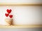 Read heart in flower pot on wood shelf