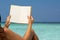 Reading book in the beach, hands holding book with blank pages,