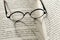 Reading.Education and schooling concept.Reading glasses close-up on the pages of a book .Symbol of study, knowledge and