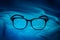 Reading eyeglasses on blue fabric background