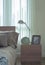 Reading lamp, clock and picture frame on bedside table