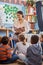 Reading opens up their imaginations even further. Shot of a teacher reading to a group of elementary school kids in