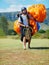 Ready for action. Shot of a man carrying his paragliding equipment.