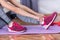 Ready for Action: Young Woman\\\'s Pre-Workout Ritual on Purple Fitness Mat