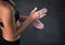 Ready for any challenge. a female athlete coating her hands with sports chalk.