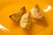 Ready baked potato slices with spices lie in orange plate