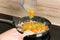 Ready for breakfast: cooking scrambled eggs in a modern kitchen