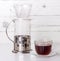 Ready coffee in a transparent glass Cup, brewed in an alternative way in a funnel v60